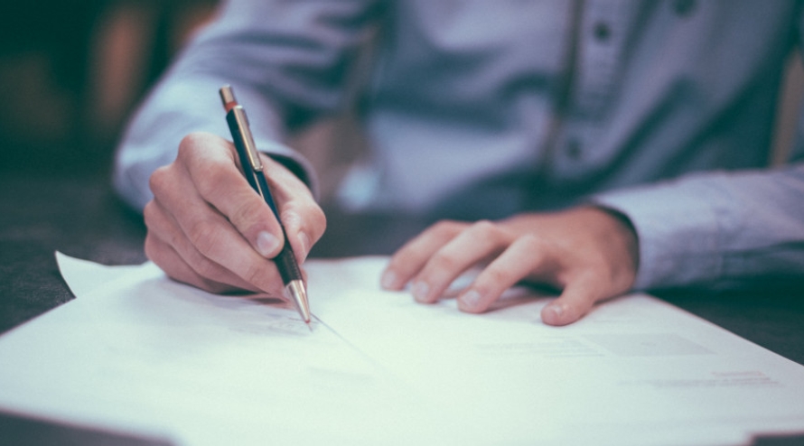 Lawyer holding a pen and signing a contract
